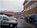 An unremarkable car park behind retail premises on Queen Street