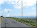 Sweeping curve in the Head Road east of Ballyveaghbeg Road