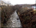 River flows past houses in Rhymney Walk in Rhymney