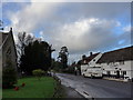 Looking from the churchyard across the High Street to The Plough