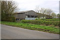 Farm buildings at Rofford Manor beside road from Little Milton