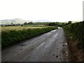 View south-westwards along a muddy Mcclenaghans Hill