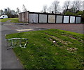 Lockup garages and an abandoned shopping trolley in Pontnewydd, Cwmbran