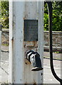 Plaque on the pump and signpost at Hexton