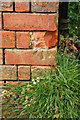 Benchmark on outbuilding at New Farm