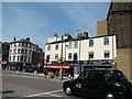 View of an old lamp post column in the middle of the road in Commercial Road