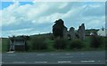 Bus Stop, Battered Bus Shelter and a Ruined Building  at Mullan