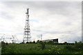 Communications mast and shed with graffiti by Derby Road