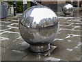 TQ3280 : Decorative Globes, Sermon Lane, London EC2 by Christine Matthews