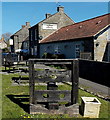 Wooden stocks outside the Drum and Monkey, Kenn