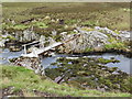 NC8427 : Remains of a footbridge over the Abhainn na Frithe by John Ferguson