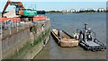 Work boat and barge in lock entrance