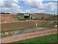 Pond beside a temporary stretch of the A453