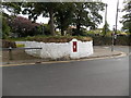 Red postbox in a white wall, St David