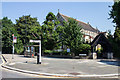 Finger post, bus stop and church