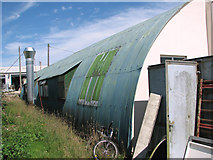 TM0198 : Nissen hut on the Industrial Estate at Stalland Common by Evelyn Simak