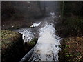 White water cascades from a sluice across the River Angiddy