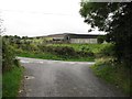 J0122 : Farm buildings above the junction of Milltown Road and Ballard Road by Eric Jones