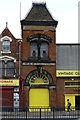 Old warehouse tower with bright yellow door and fanlight