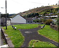 Benches alongside a path in Pontycymer