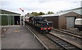 Steam train passing the Strathspey Railway sheds