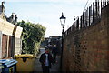 View of a cobbled walkway at the back of the shops on the High Street