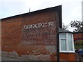 Faded advertisement opposite the parish church