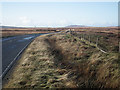NF8967 : Looking west on the A867 road out of Lochmaddy by John Lucas