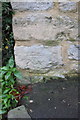SP3917 : Benchmark on cottage at Combe Road junction by Roger Templeman