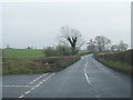 Road junction, but that on left leads to gated drive