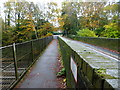 Footbridge beside road bridge over railway