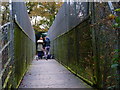 Group of photographers on footbridge over railway