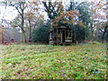 Wooden building by field path