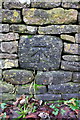 Benchmark on stone in wall beside B4026