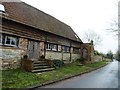 Minor road and old building by Yew Tree Farm