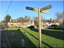 SP5019 : Signpost on the Green by Des Blenkinsopp