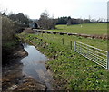 Field gates and a pipeline at the edge of  the Ewenny River, Ewenny