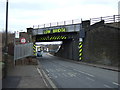 Low railway bridge crossing Station Road