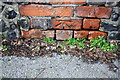 Benchmark on All Saints churchyard wall