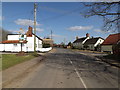 TM2281 : High Road & Needham Village sign by Geographer