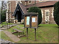 SO5707 : Noticeboard, bench and ornate doorway, St Peter's Church, Clearwell  by Jaggery