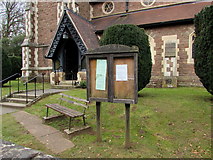 SO5707 : Noticeboard, bench and ornate doorway, St Peter's Church, Clearwell  by Jaggery