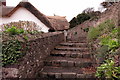 Steps up to the thatched cottage