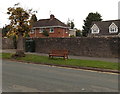 Bench and tree on a grassy strip in Monmouth