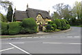 Thatched cottage with billowing hedge