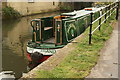 View of Maris Piper moored on the River Lea from the Lea towpath