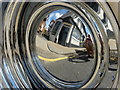 Reflection of The Chimney Boy in a Chevrolet wheel in Preston Street