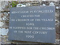 Plaque on the churchyard wall