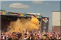 View of the presenter using a colour shooter at the Colour Run