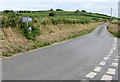 Signpost facing a holiday park exit road near Kidwelly